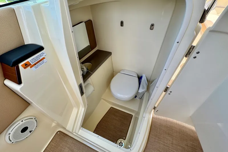  Yacht Photos Pics 2023 Chris-Craft Calypso 28 boat interior bathroom with toilet and sink.