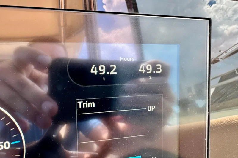  Yacht Photos Pics Display screen on 2023 Chris-Craft Calypso 28 showing engine hours and trim settings.