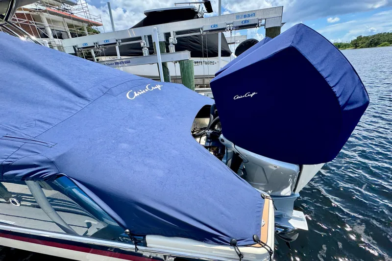  Yacht Photos Pics 2023 Chris-Craft Calypso 28 boat with blue covers docked by the water.