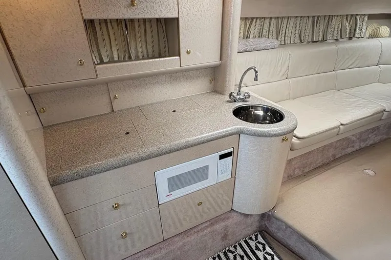  Yacht Photos Pics 2001 Formula 400ss yacht interior with kitchenette, sink, microwave, and seating area.