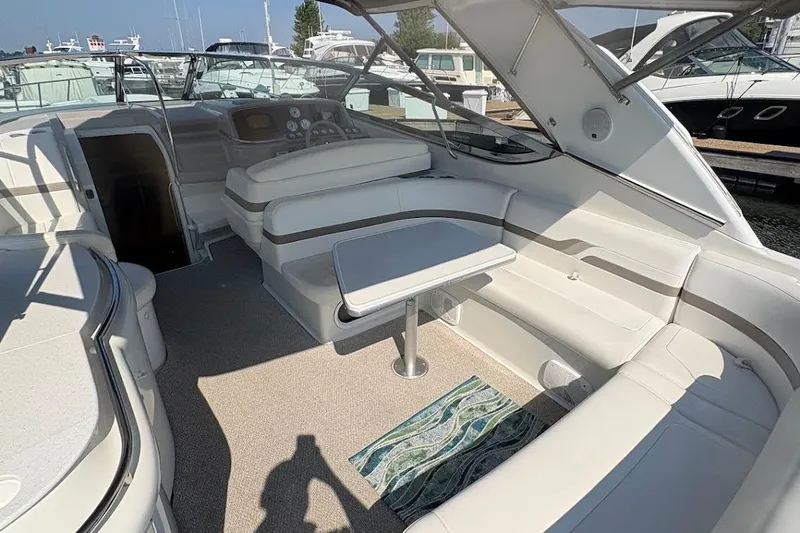  Yacht Photos Pics 2001 Formula 400ss boat interior with white seating and table in a marina setting.