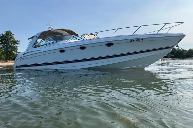  Yacht Photos Pics 2001 Formula 400ss boat on calm water, side view with trees in background.