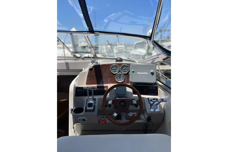 Bella Olivia Yacht Photos Pics Helm of 2000 Regal Commodore 4160 with steering wheel and navigation instruments.