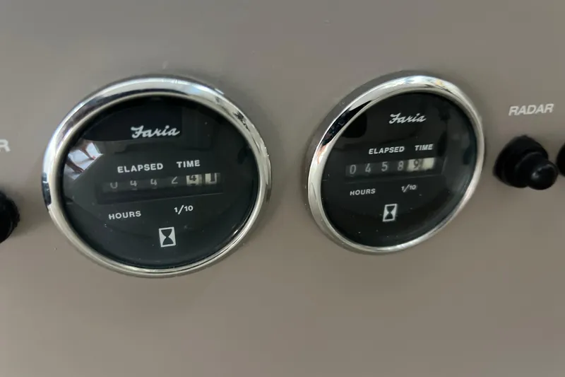 Bella Olivia Yacht Photos Pics Close-up of Faria elapsed time gauges on a 2000 Regal Commodore 4160 boat.