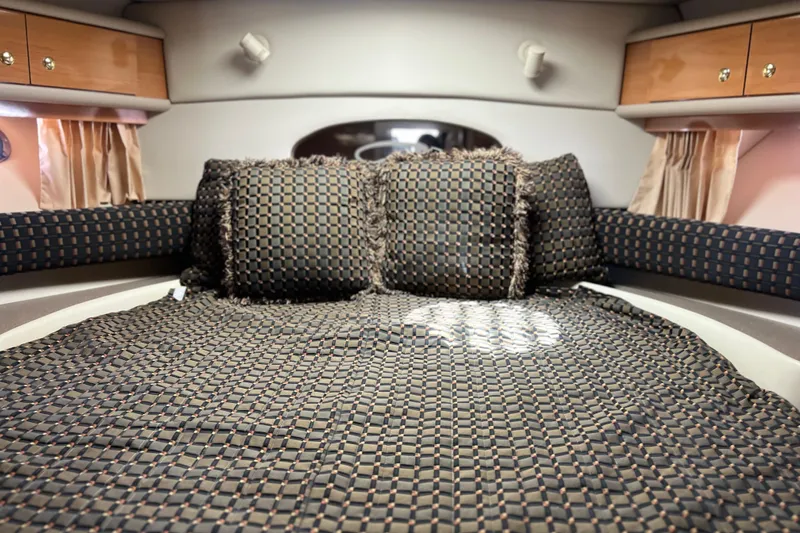 Bella Olivia Yacht Photos Pics Interior cabin of 2000 Regal Commodore 4160 yacht with patterned bedding and cushions.