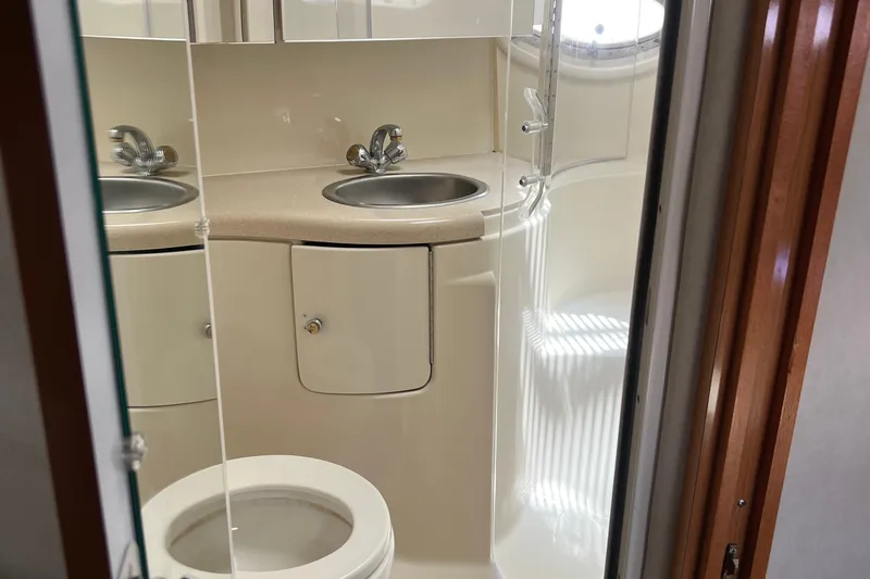 Bella Olivia Yacht Photos Pics Bathroom interior of 2000 Regal Commodore 4160 yacht with dual sinks and toilet.