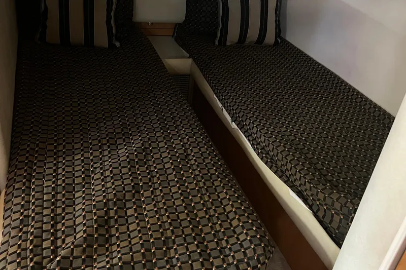 Bella Olivia Yacht Photos Pics Twin beds with patterned covers in a 2000 Regal Commodore 4160 cabin.