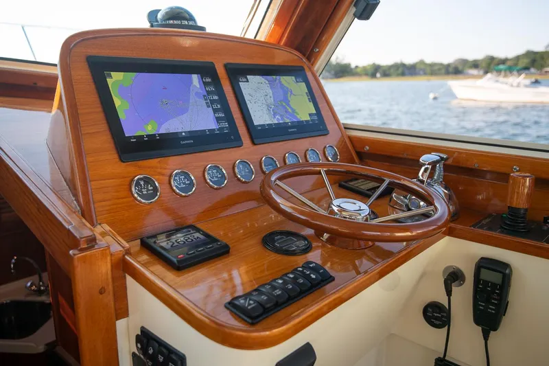 Eroica Yacht Photos Pics Helm of 2005 Hinckley Talaria 40 with dual navigation screens and wooden steering wheel.
