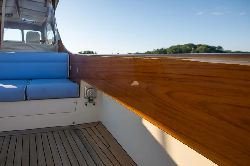 Eroica Yacht Photos Pics 2005 Hinckley Talaria 40 boat interior with blue seating and polished wood finish.