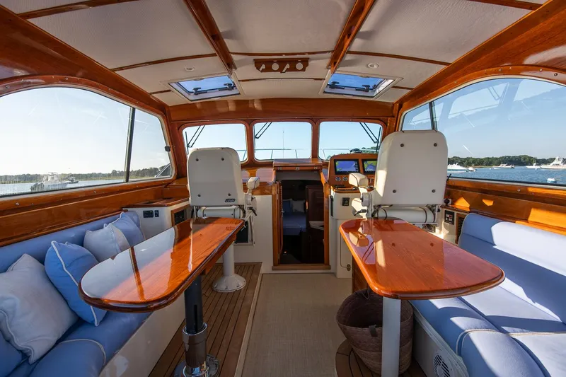 Eroica Yacht Photos Pics Interior of 2005 Hinckley Talaria 40 yacht with wooden accents and blue seating.