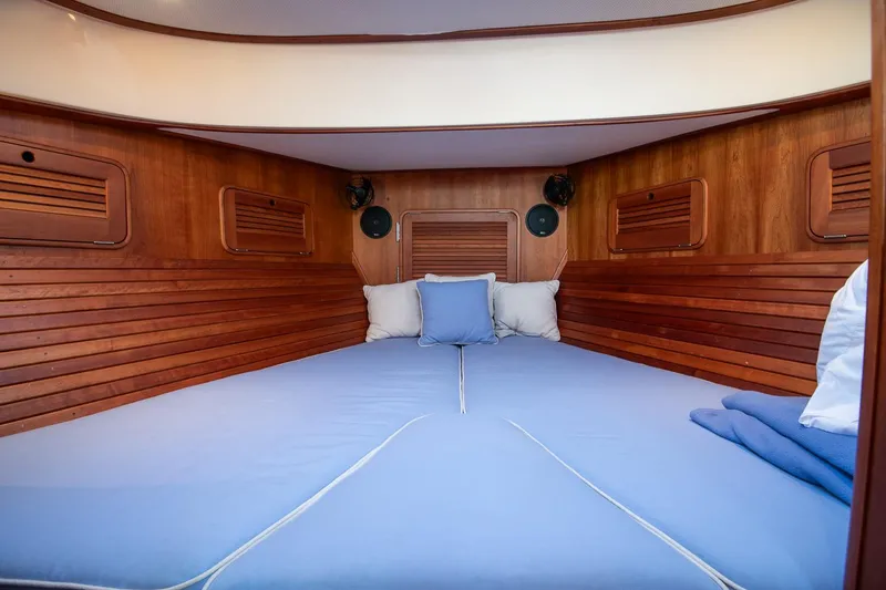Eroica Yacht Photos Pics 2005 Hinckley Talaria 40 cabin interior with wooden paneling and blue bedding.