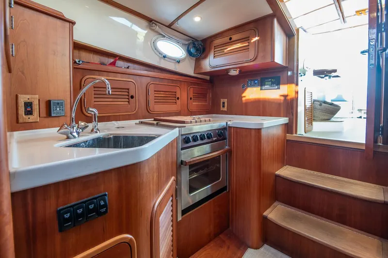 Eroica Yacht Photos Pics 2005 Hinckley Talaria 40 yacht interior with wooden cabinetry and modern kitchen amenities.