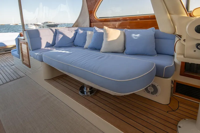 Eroica Yacht Photos Pics Luxurious 2005 Hinckley Talaria 40 yacht interior with blue cushioned seating.