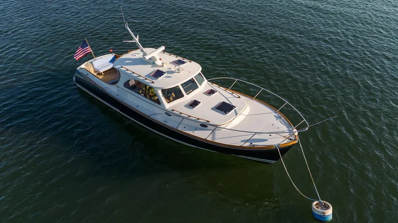 Eroica Yacht Photos Pics 2005 Hinckley Talaria 40 yacht anchored on calm water with American flag.