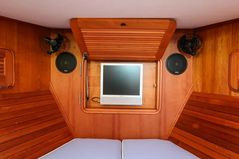 Eroica Yacht Photos Pics Interior of 2005 Hinckley Talaria 40 with wooden paneling and built-in TV.