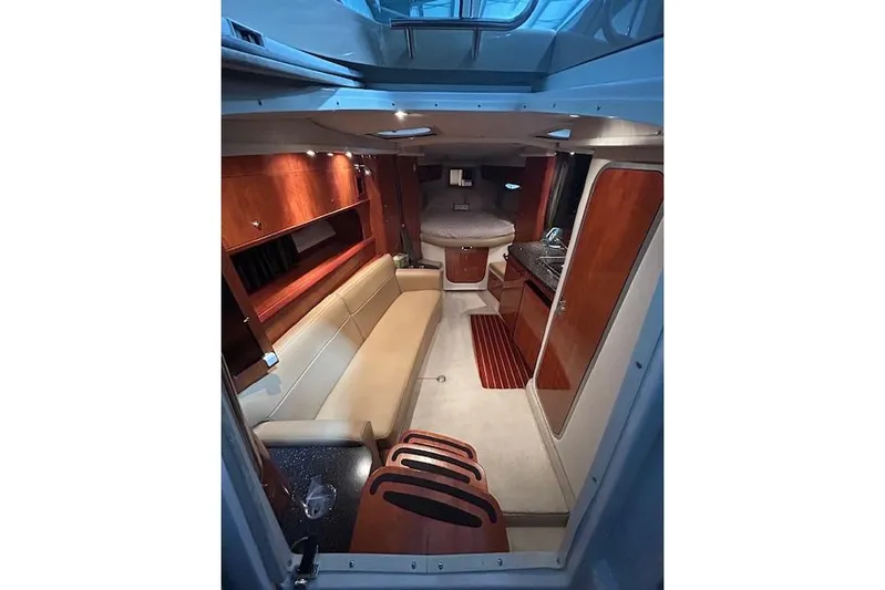 Gorgie Yacht Photos Pics 2008 Four Winns 338 Vista cabin interior with seating, kitchenette, and cozy sleeping area.