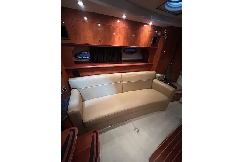 Gorgie Yacht Photos Pics Interior of 2008 Four Winns 338 Vista yacht with beige sofa and wooden cabinetry.