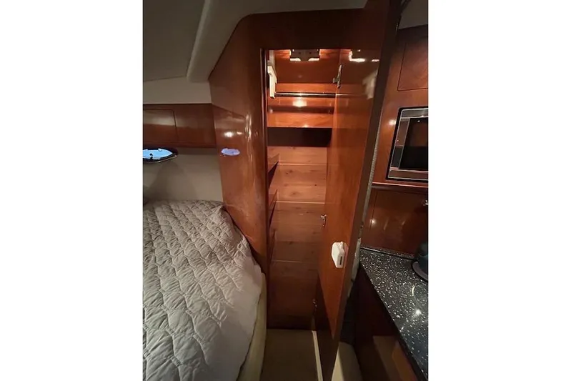 Gorgie Yacht Photos Pics Interior of 2008 Four Winns 338 Vista yacht with wood cabinetry and cozy sleeping area.