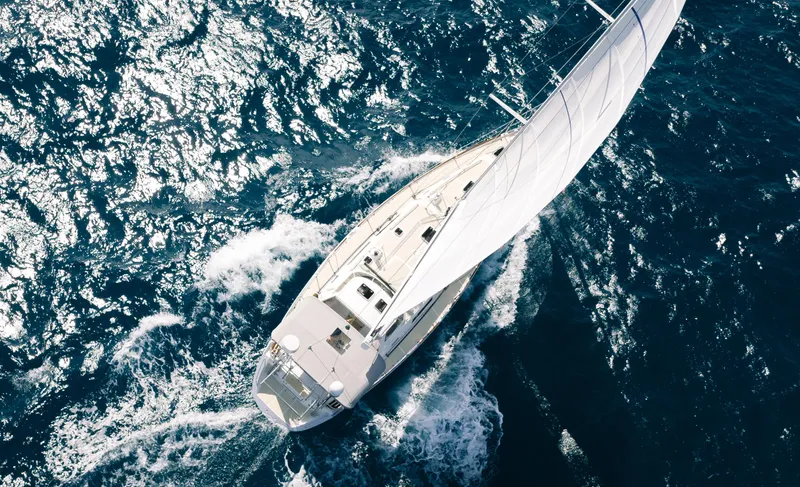 Outbound 46 Yacht Photos Pics Aerial view of 2025 Outbound 46 sailboat navigating through ocean waves.