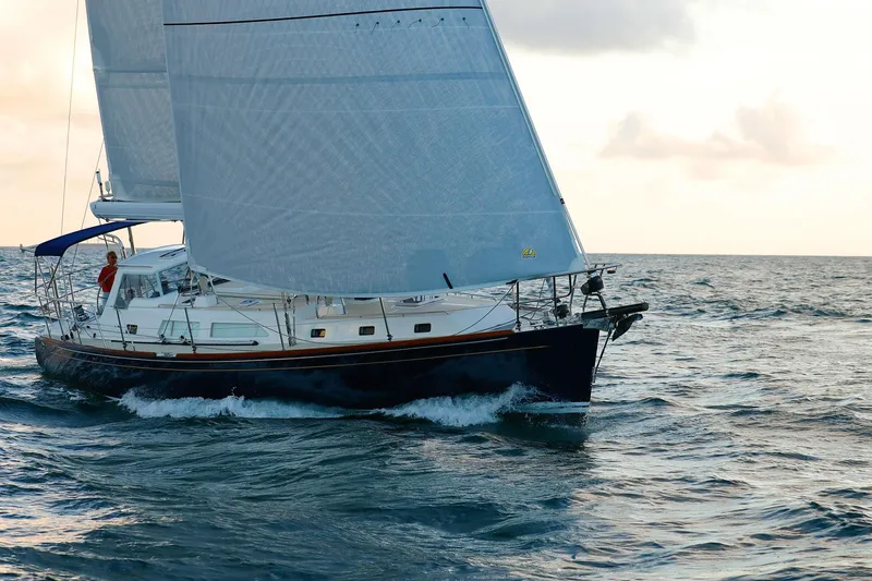 Outbound 46 Yacht Photos Pics Sailing yacht Outbound 46, 2025 model, cruising on open sea at sunset.