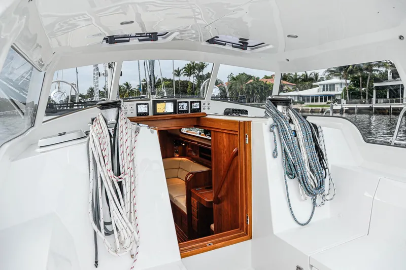 Outbound 46 Yacht Photos Pics Outbound 46 yacht cockpit, 2025 model, featuring ropes and a wooden cabin entrance.