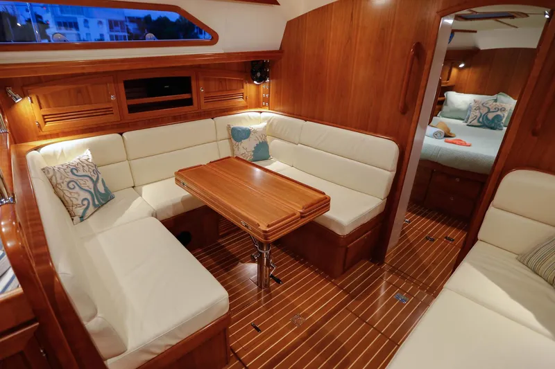 Outbound 46 Yacht Photos Pics Luxurious interior of 2025 Outbound 46 yacht with elegant wood finish and cozy seating area.