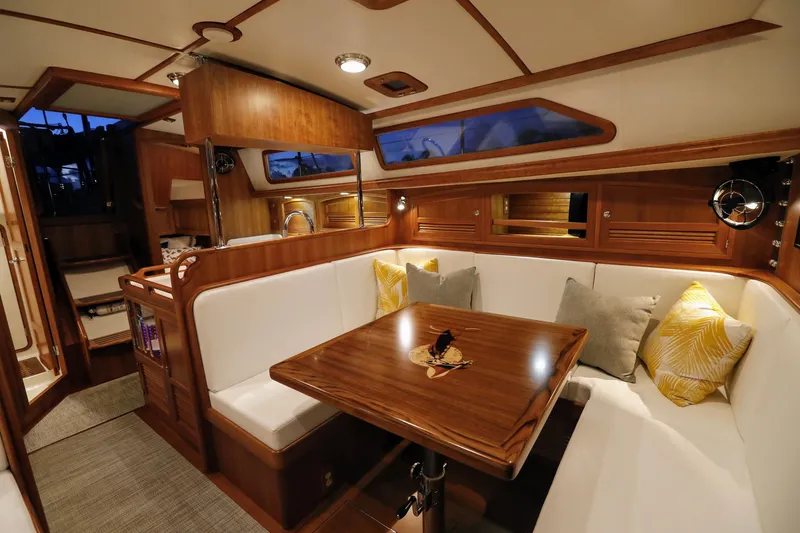 Outbound 46 Yacht Photos Pics Luxurious interior of 2025 Outbound 46 yacht with elegant wood finish and cozy seating.
