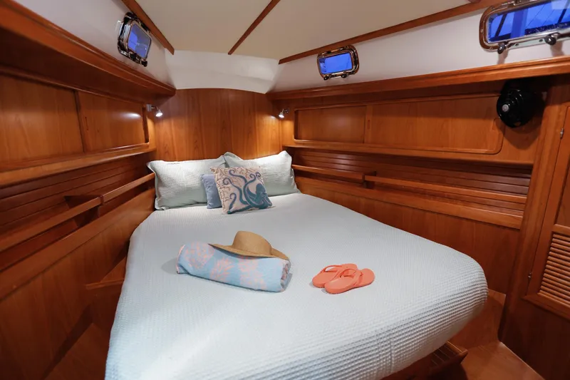 Outbound 46 Yacht Photos Pics Luxurious cabin interior of 2025 Outbound 46 yacht with cozy bed and nautical decor.
