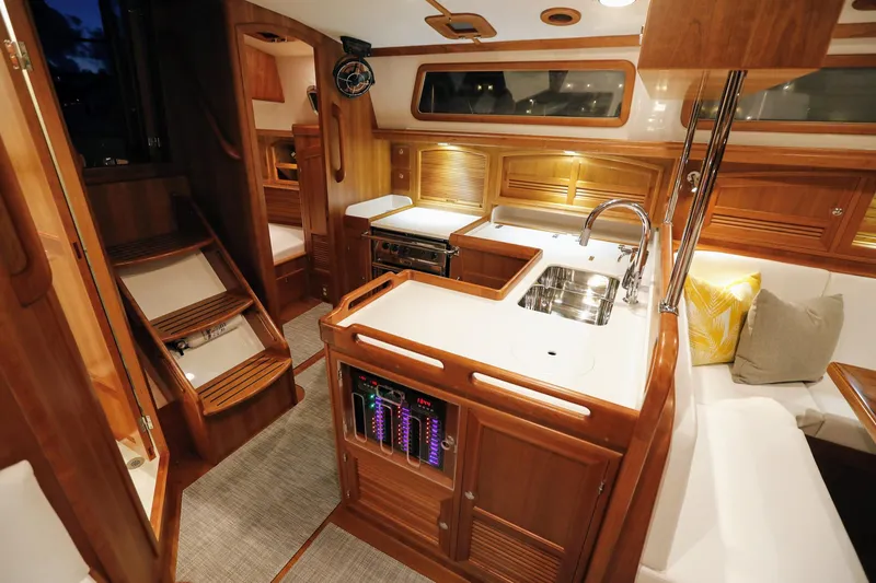 Outbound 46 Yacht Photos Pics Luxurious 2025 Outbound 46 yacht interior with modern kitchen and elegant wood finishes.