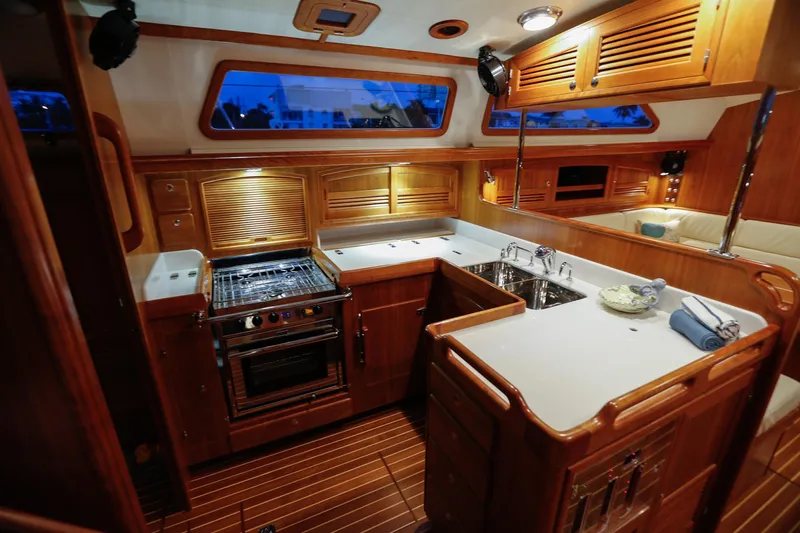 Outbound 46 Yacht Photos Pics Luxurious 2025 Outbound 46 yacht kitchen with wood cabinetry and modern appliances.