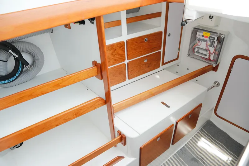 Outbound 46 Yacht Photos Pics Interior of 2025 Outbound 46 sailboat with wooden cabinetry and storage compartments.