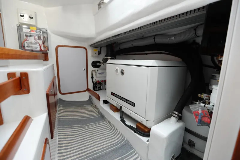 Outbound 46 Yacht Photos Pics Engine room of 2025 Outbound 46 yacht with generator and control panel.