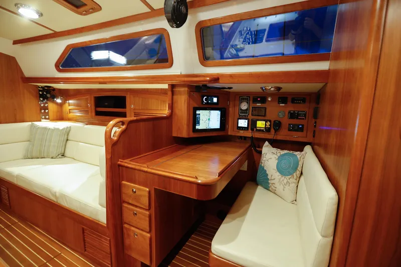 Outbound 46 Yacht Photos Pics Luxurious interior of 2025 Outbound 46 yacht with wood finish and navigation equipment.