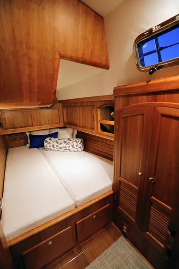 Outbound 46 Yacht Photos Pics 2025 Outbound 46 yacht cabin with wooden interior and cozy bed.