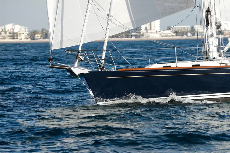 Outbound 46 Yacht Photos Pics Sailing yacht Outbound 46, 2025 model, cruising on open water near a coastal city.