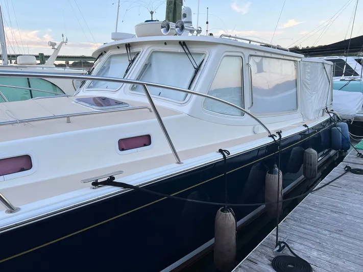 Liberty Yacht Photos Pics 2013 MJM 40z Downeast boat docked at marina with fenders.