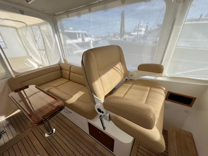 Liberty Yacht Photos Pics Interior of 2013 MJM 40z Downeast boat with beige seating and wooden flooring.