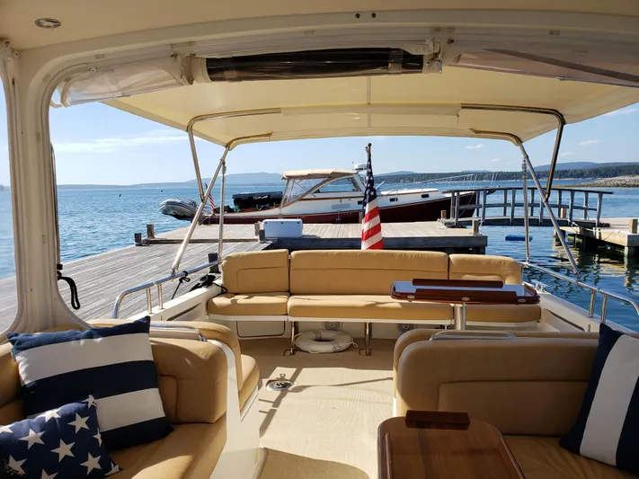Liberty Yacht Photos Pics Interior view of 2013 MJM 40z Downeast yacht with dock and ocean backdrop.