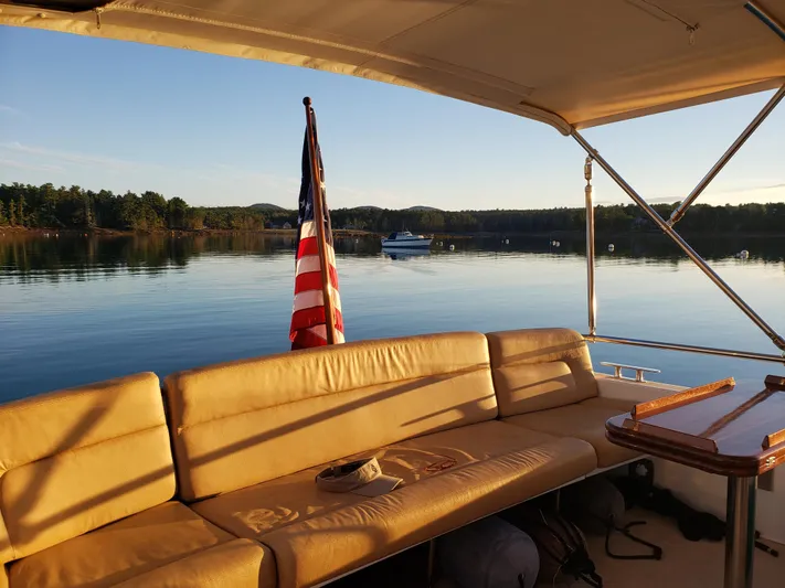 Liberty Yacht Photos Pics 2013 MJM 40z Downeast boat interior with American flag, serene lake view.