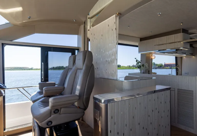  Yacht Photos Pics Luxurious interior of 2026 Galeon 620 FLY yacht with modern seating and scenic water view.