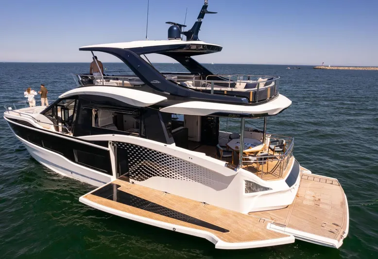  Yacht Photos Pics Luxurious 2026 Galeon 620 FLY yacht cruising on open water, featuring elegant design and spacious decks.