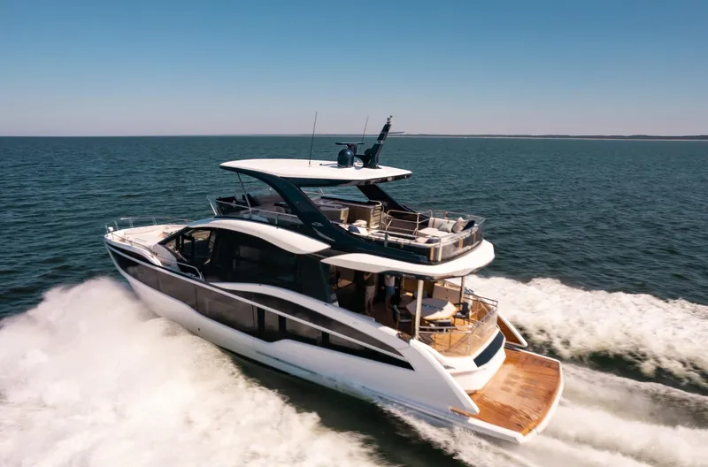  Yacht Photos Pics 2026 Galeon 620 FLY yacht cruising on open sea under clear blue sky.