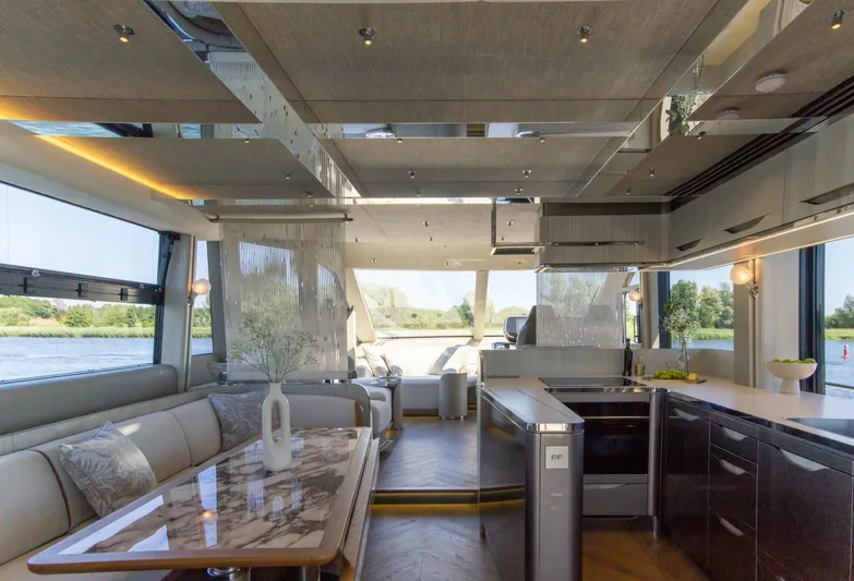  Yacht Photos Pics Luxurious interior of 2026 Galeon 620 FLY yacht with modern kitchen and elegant dining area.