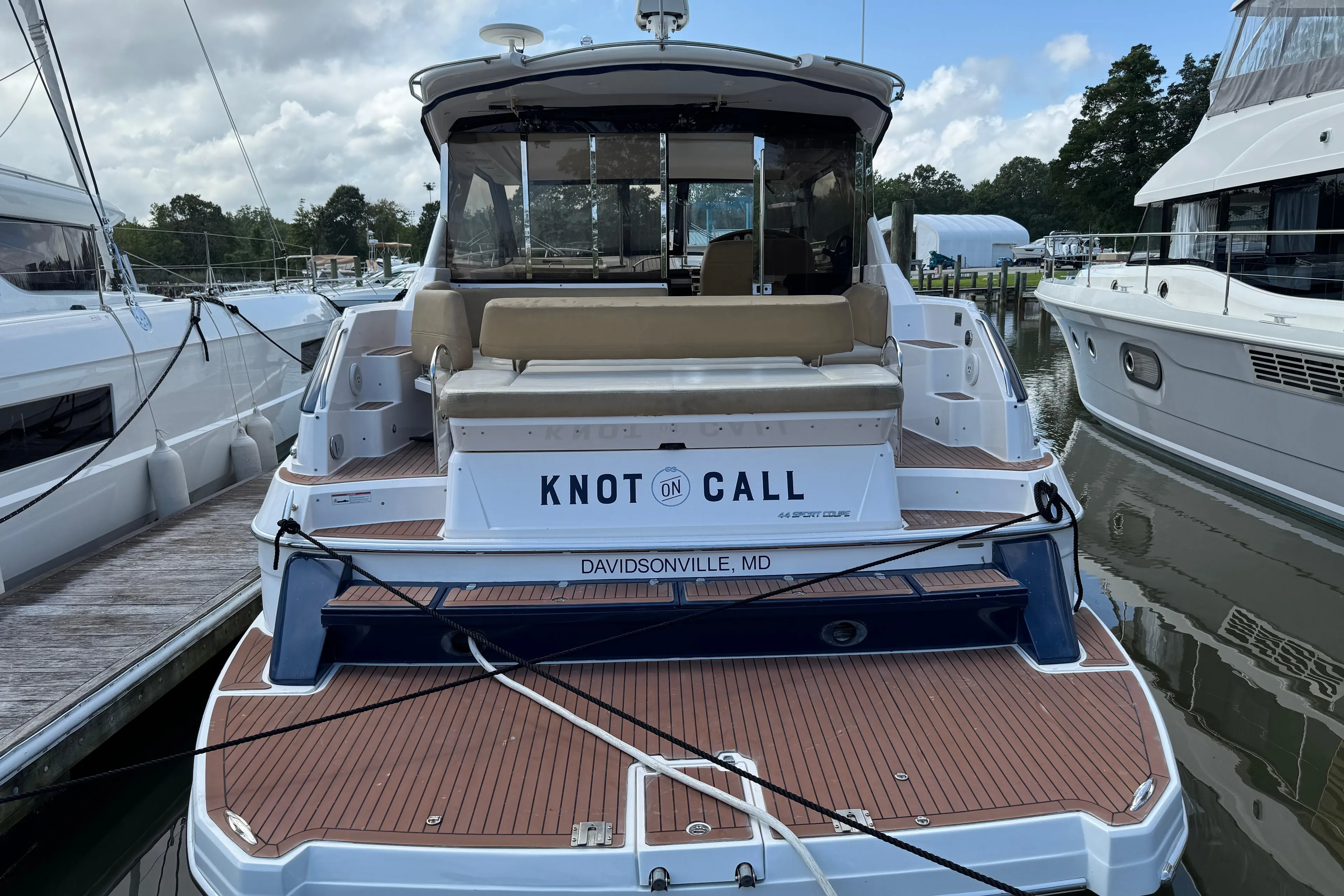 2010 Regal 44 Sport Coupe yacht docked, rear view with "Knot on Call" nameplate.