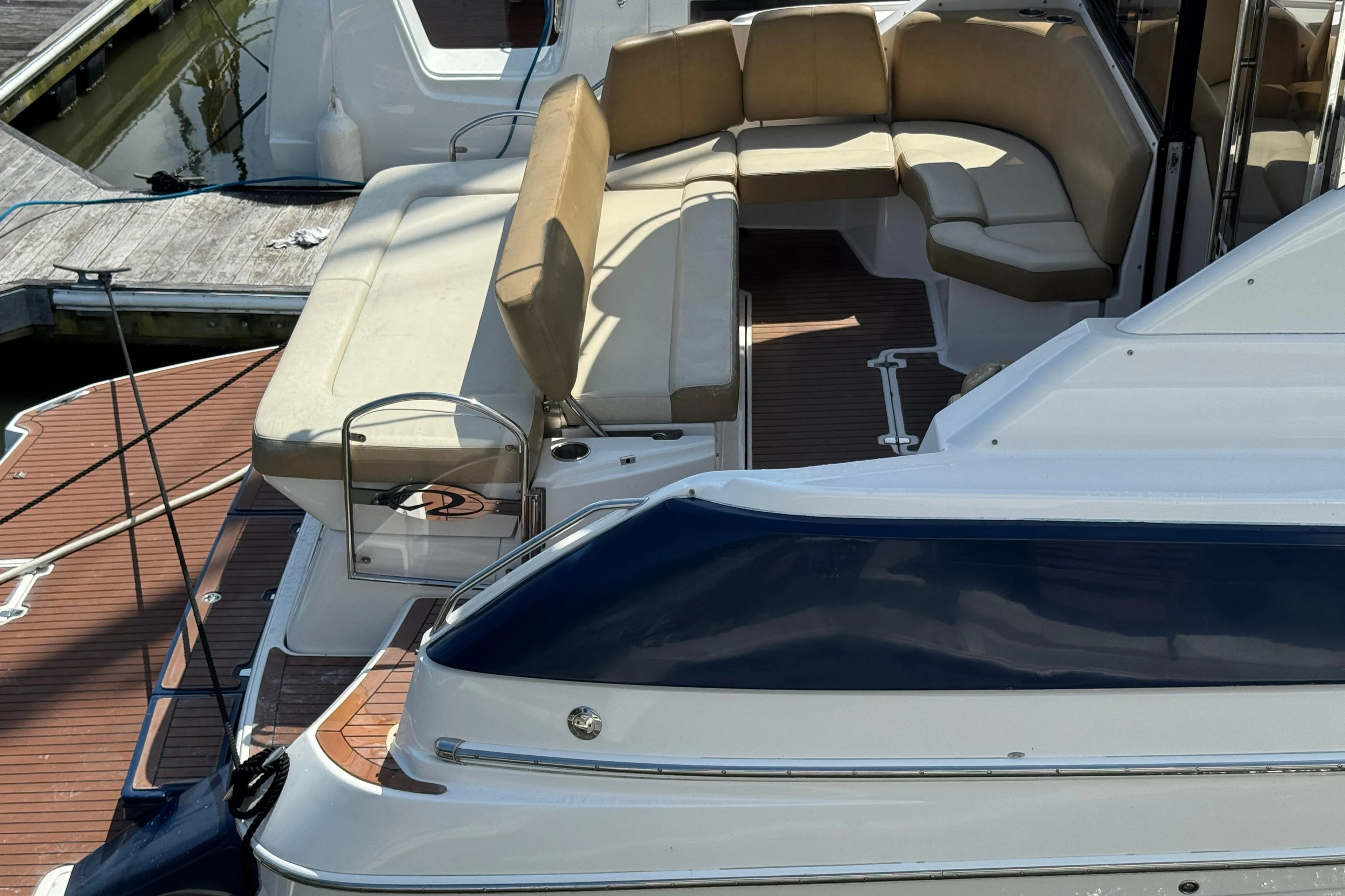 2010 Regal 44 Sport Coupe yacht with spacious deck seating at the marina.