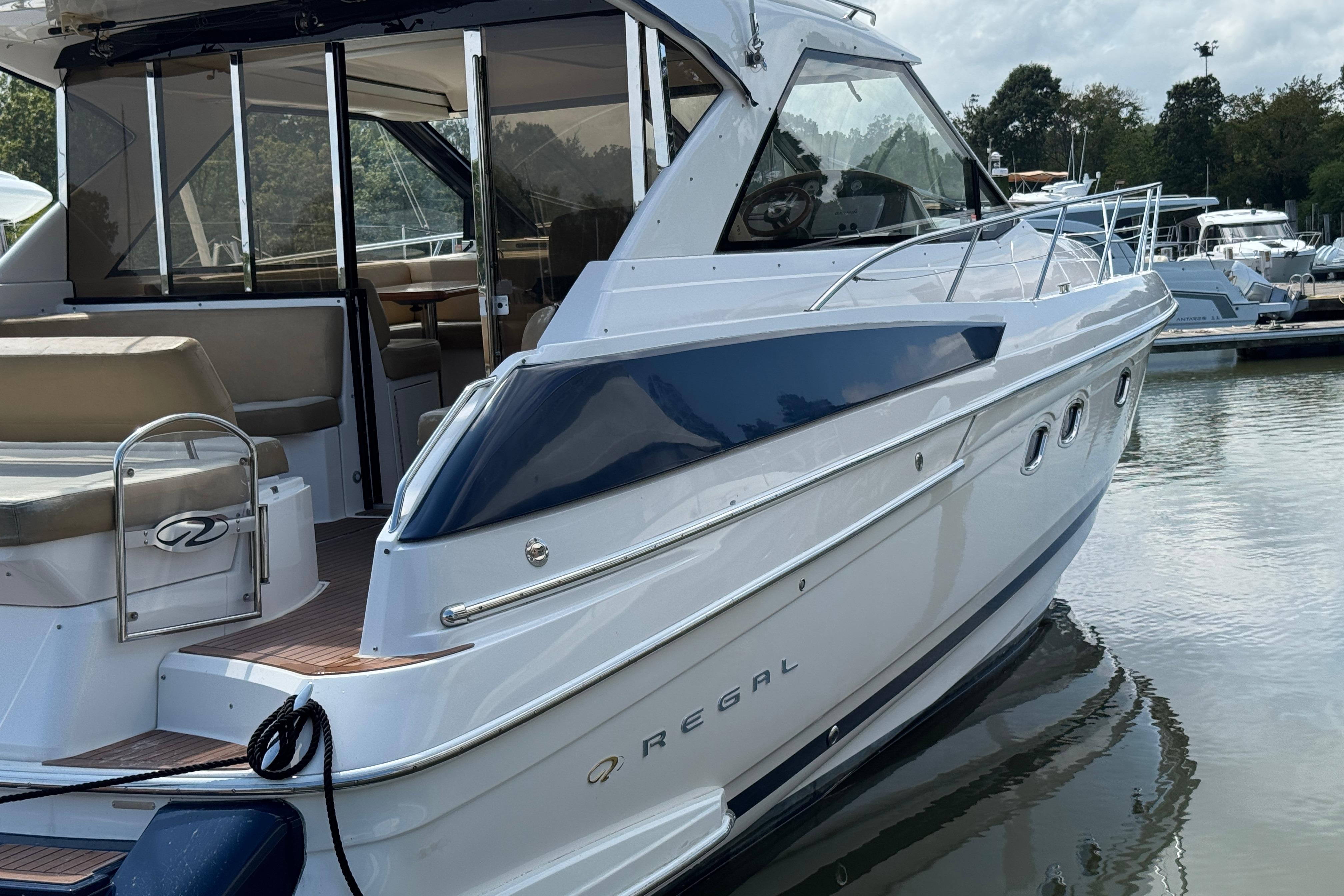 2010 Regal 44 Sport Coupe yacht docked at marina, featuring sleek design and spacious interior.