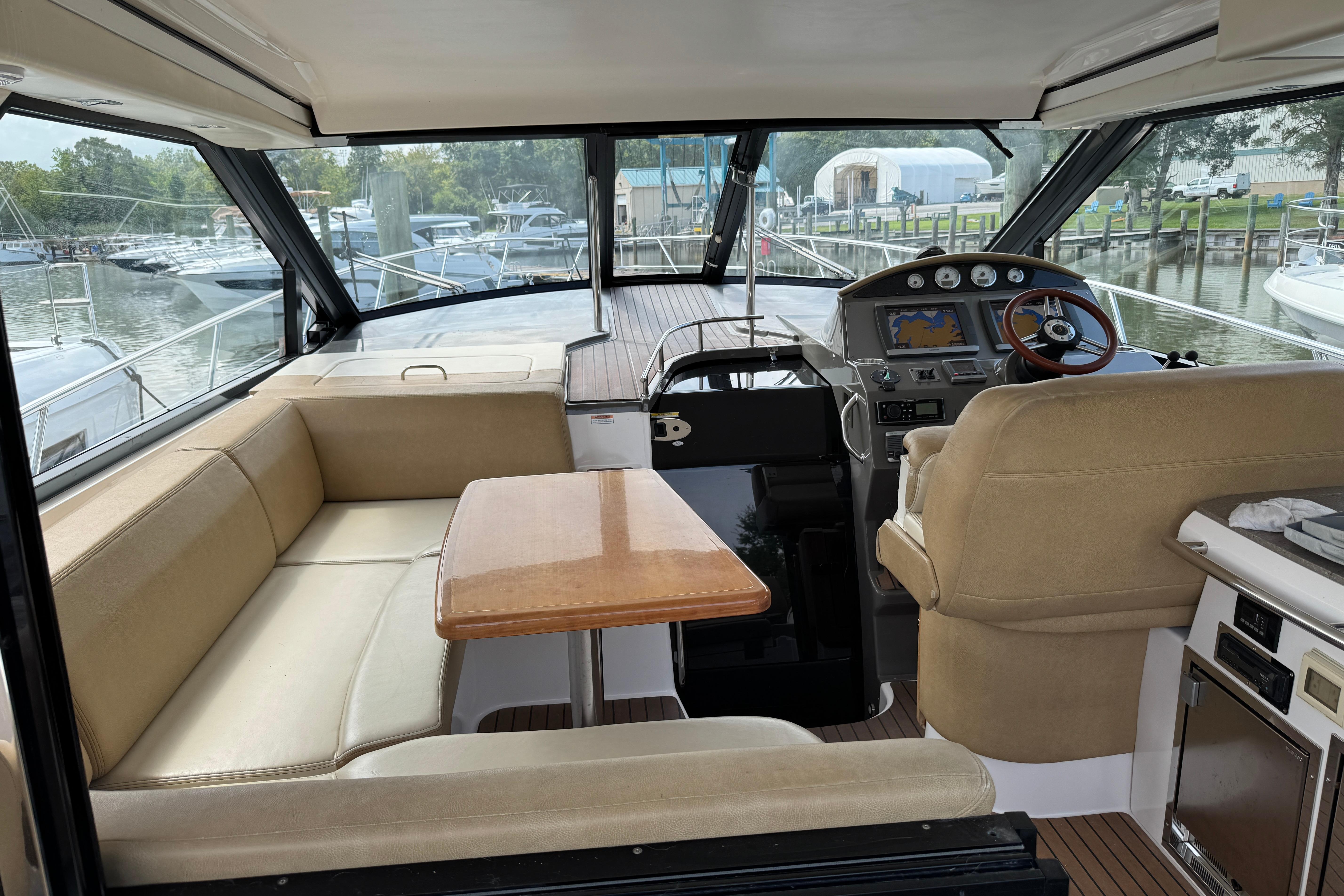 Interior of 2010 Regal 44 Sport Coupe yacht with helm, seating, and table.