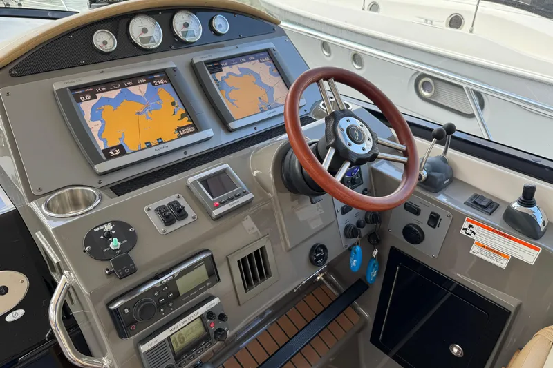  Yacht Photos Pics Control panel of a 2010 Regal 44 Sport Coupe with navigation screens and steering wheel.