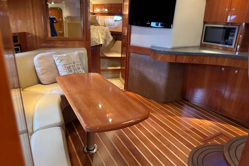  Yacht Photos Pics Luxurious interior of a 2010 Regal 44 Sport Coupe yacht with wood finishes and modern amenities.