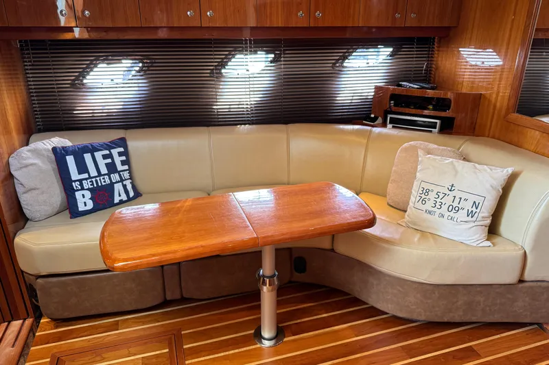  Yacht Photos Pics Luxurious 2010 Regal 44 Sport Coupe interior with cozy seating and nautical-themed pillows.